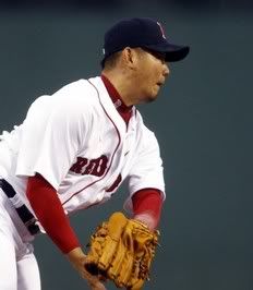 Boston Red Sox starting pitcher Daisuke Matsuzaka reacts after being hit by a line drive off the bat of Baltimore Orioles' Brian Roberts during the first inning of their MLB American League baseball game at Fenway Park in Boston, Massachusetts May 16, 2011.