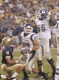 University of Connecticut's Donald Brown (34) looks to a referee to see if he scored at the end of the second half at Heinz Field in Pittsburgh on Saturday, Sept. 22, 2007. He was ruled just short of a touchdown, but UConn scored on the next play. At left is Pittsburgh's Mike Phillips and at right is UConn's Donald Thomas.