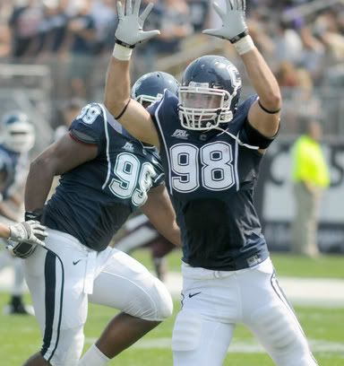 UConn's Ted Jennings (No. 98), right, and Kendall Reyes (No. 99) try to block Fordham's quarterback Peter Maetzold (No. 6) during the second half of UConn football opener at Rentschler Field against Fordham on Saturday. UConn won 35-3. 