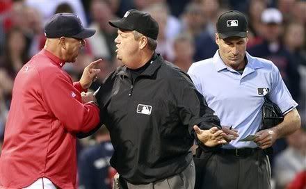 Third base umpire Joe West, center, gets between Boston Red Sox manager Terry Francona, left, and home plate umpire Angel Hernandez after Hernandez ejected Francona for arguing a balk in the second inning of a baseball game against the Minnesota Twins, Friday, May 6, 2011, in Boston.