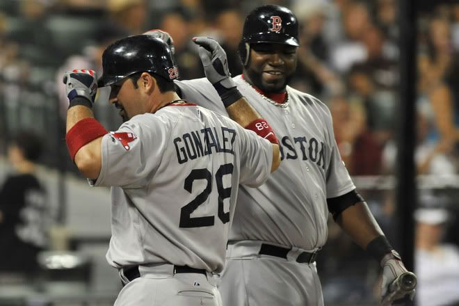 Adrian Gonzalez(notes) #28 of the Boston Red Sox is greeted by teammate David Ortiz(notes) #34 after hitting a two-run home run in the ninth inning against the Chicago White Sox on July 30, 2011 at U.S. Cellular Field in Chicago, Illinois.