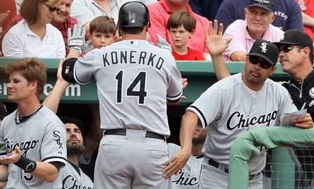 Ozzie Guillen #13 of the Chicago White Sox congratulates Paul Konerko(notes) #14 after he hit a two run homer in the ninth inning against the Boston Red Sox on June 1, 2011 at Fenway Park in Boston, Massachusetts. The Chicago White Sox defeated the Boston Red Sox 7-4.