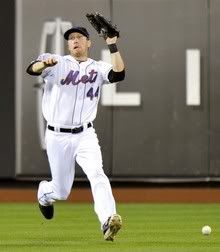 New York Mets left fielder Jason Bay fails to catch a ball hit by Cincinnati Reds batter Jay Bruce in the ninth inning of their MLB National League baseball game in New York, July 6, 2010.