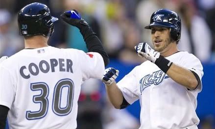 Toronto Blue Jays' J.P. Arencibia(notes), right, celebrates a three-run home run with teammate David Cooper(notes) in the second inning of MLB game baseball action against the Boston Red Sox in Toronto, Thursday, Sept. 8, 2011
