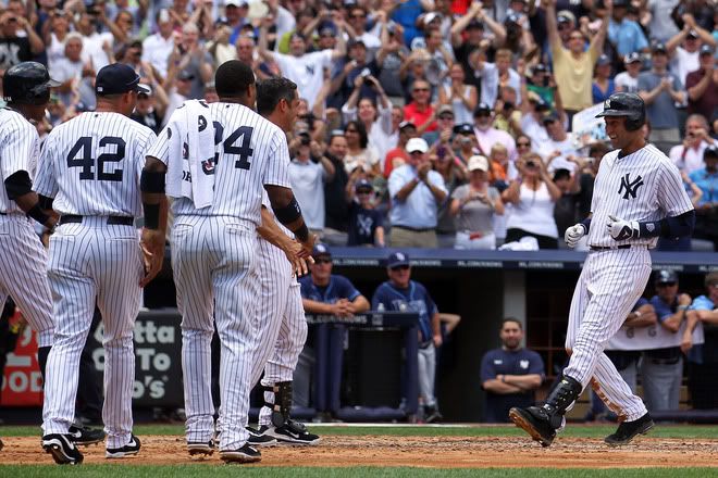 Derek Jeter(notes) #2 of the New York Yankees is greeted by his teammates after hitting a solo home run in the third inning for career hit 3000 while playing against the Tampa Bay Rays at Yankee Stadium on July 9, 2011 in the Bronx borough of New York City. 