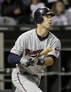 Minnesota Twins' Joe Mauer watches after hitting a three-run home run against the Chicago White Sox during the fifth inning of a baseball game in Chicago, Wednesday, Sept. 15, 2010.