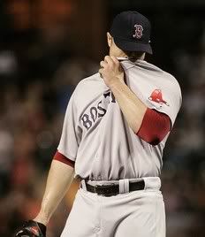 Boston Red Sox starting pitcher Jon Lester reacts after giving up a two-run home run to J. J. Hardy of the Baltimore Orioles in the third inning of their MLB American League baseball game in Baltimore, Maryland September 28, 2011