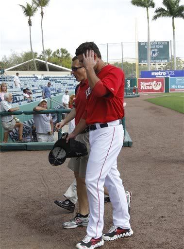 Boston Red Sox pitcher Josh Beckett(notes) holds his head as he is led from the field after being hit by a ball during batting practice prior to the Red Sox's spring training baseball game against the Minnesota Twins at City of Palms Park in Fort Myers, Fla., Monday, Feb. 28, 2011. Beckett has mild concussion symptoms, according to the team.