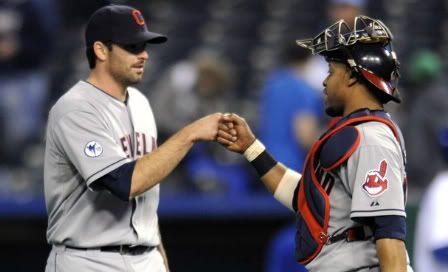 Cleveland Indians relief pitcher Justin Germano and catcher Carlos Santana celebrate the Indians tenth inning win over the Kansas City Royals in their MLB American League baseball game in Kansas City, Missouri, April 18, 2011.