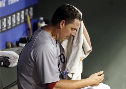 Boston Red Sox starting pitcher John Lackey(notes) sits in the dugout after he was pulled from the game in the fourth inning of the baseball game against the Texas Rangers in Arlington, Texas, Saturday, April 2, 2011.