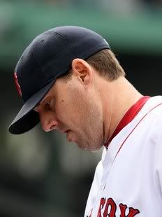 John Lackey #41 of the Boston Red Sox walks into the dugout after he was pulled from the game against the Los Angeles Angels on May 5, 2011 at Fenway Park in Boston, Massachusetts.