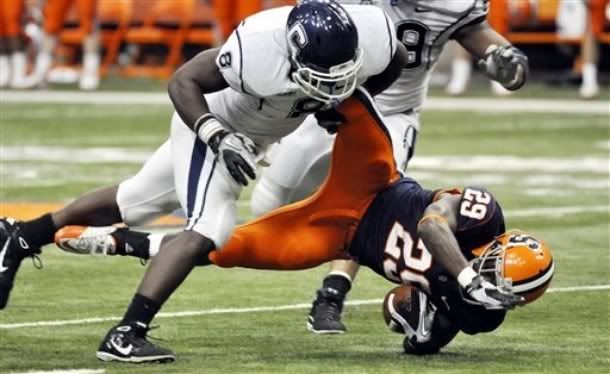 Connecticut's Lawrence Wilson, left, tackles Syracuse's Antwon Bailey during the third quarter of an NCAA college football game in Syracuse, N.Y. , Saturday, Nov. 20, 2010. Connecticut won 20-6.