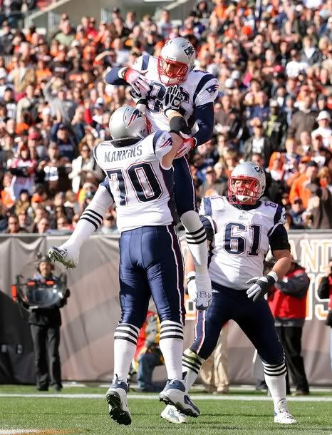 Tight end Aaron Hernandez #85 of the New England Patriots celebrates with Logan Mankins #70 and Stephen Neal #61 after scoring a touchdown against the Cleveland Browns at Cleveland Browns Stadium on November 7, 2010 in Cleveland, Ohio.