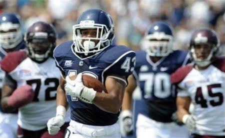 Connecticut's Lyle McCombs is pursued by Fordham's Justin Yancey (72) and Jake Rodriques (45) while making a 60-yard run during the first half of an NCAA college football game in East Hartford, Conn. , on Saturday, Sept. 3, 2011.