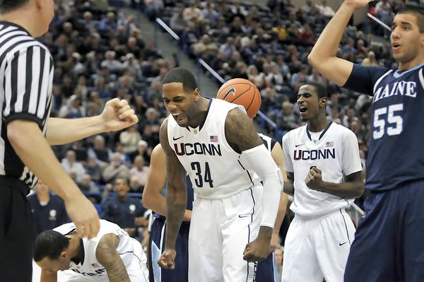 Alex Oriakhi, center, and DeAndre Daniels react after Shabazz Napier scored while being fouled by Maine's Svetoslav Chetinov during UConn's 80-60 win. Oriakhi and Jeremy Lamb finished with a team high 16 points each.