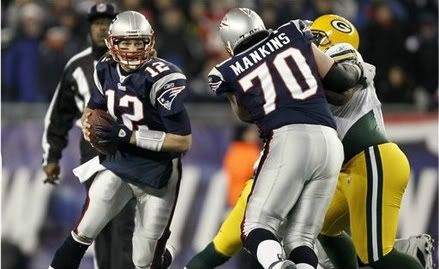 New England Patriots quarterback Tom Brady scrambles past the block of New England Patriots guard Logan Mankins (70) during the first quarter of a NFL football game against the Green Bay Packers at Gillette Stadium in Foxborough, Mass.