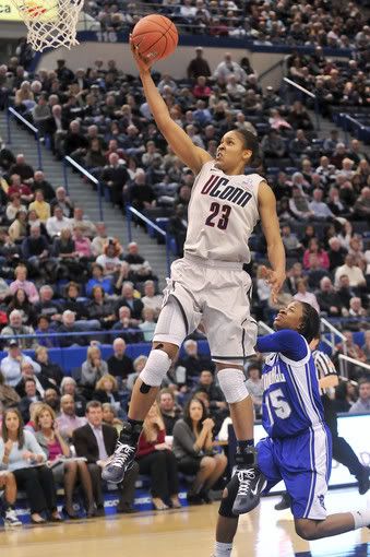 Maya Moore of UConn slides in for two points after making a steal against Jazzmine Johnson of Seton Hall during the second half. Moore finished the night with 20 points, six rebounds and five assists in an 80-59 victory Tuesday night at the XL Center in Hartford. 