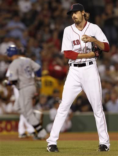 Boston Red Sox starting pitcher Andrew Miller(notes), right, reacts after giving up a solo home run to Kansas City Royals designated hitter Billy Butler(notes) (16) who rounds third base, left rear, during the fourth inning of a baseball game, Tuesday, July 26, 2011, at Fenway Park in Boston.