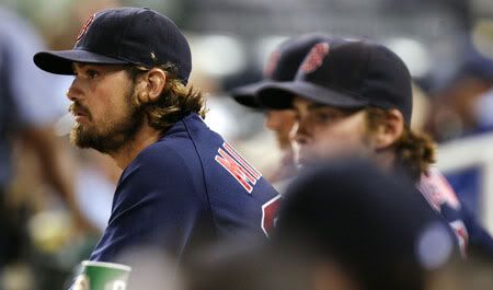 Starting pitcher Andrew Miller(notes) #30 of the Boston Red Sox watches from the dugout after leaving the game in the sixth inning at Kauffman Stadium on August 19, 2011 in Kansas City, Missouri. 