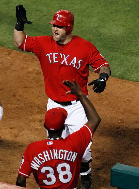Mike Napoli(notes) #25 of the Texas Rangers celebrates with Manager Ron Washington #38 after scoring a three-run homerun against the Boston Red Sox at Rangers Ballpark in Arlington on August 22, 2011 in Arlington, Texas