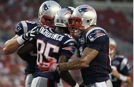 New England Patriots wide receiver Chad Ochocinco (85) gets congratulations from teammates including Aaron Hernandez, right, after his first quarter touchdown against the Tampa Bay Buccaneers during an NFL preseason football game Thursday, Aug. 18, 2011 in Tampa, Fla. 