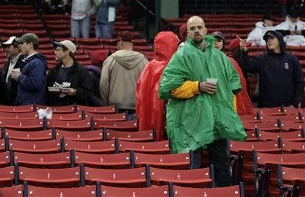 Boston Red Sox baseball fan Eric Moore, of Attleboro, Mass., front right, reacts after hearing that the Red Sox's game against the Baltimore Orioles has been postponed due to rain, in Boston, Tuesday, May 17, 2011.