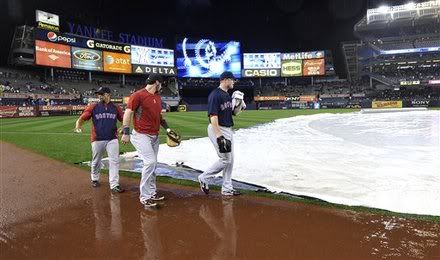 Boston Red Sox pitcher Jon Lester(notes), right, catcher, Jarrod Saltalamacchia(notes), center, and support staff Mani Martinez walk off the rain-soaked field after the game against the New York Yankees was postponed due to rain on Friday, Sept. 23, 2011, at Yankee Stadium in New York. Lester was supposed to be the starting pitcher for the game.