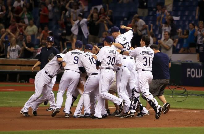 The Tampa Bay Rays celebrate the win against the Boston Red Sox after the game on September 10, 2011 at Tropicana Field in St. Petersburg, Florida.