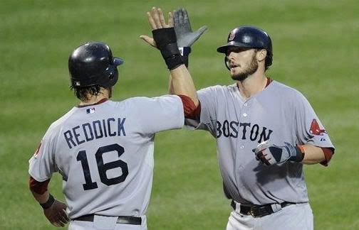 Boston Red Sox's Jarrod Saltalamacchia, right, celebrates his two-run home run with Josh Reddick (16) during the fifth inning of a baseball game against the Baltimore Orioles, Tuesday, July 19, 2011, in Baltimore