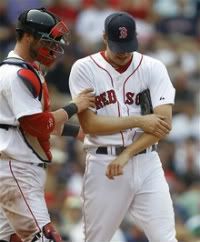 Boston Red Sox pitcher Rich Hill, right, is assisted by Red Sox catcher Jarrod Saltalamacchia as he leaves the game with a forearm injury after facing just one batter in the seventh inning of a baseball game against the Chicago White Sox, Wednesday, June 1, 2011, at Fenway Park, in Boston.