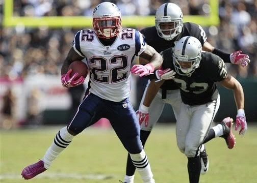New England Patriots running back Stevan Ridley, left, breaks away from Oakland Raiders safety Tyvon Branch, right, and cornerback Stanford Routt to score a touchdown on a 33-yard run during the third quarter of their NFL football game in Oakland, Calif., Sunday, Oct. 2, 2011.