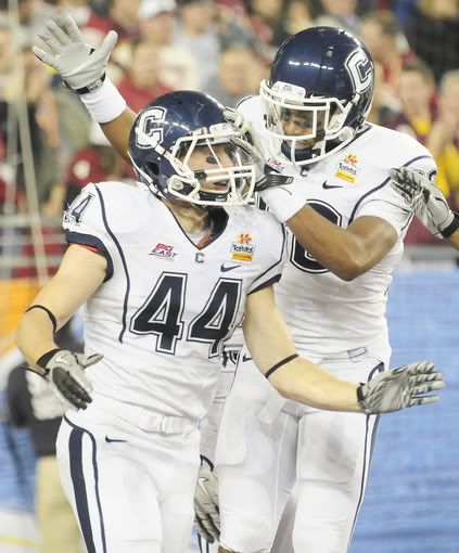 UConn's Robbie Frey is congratulated by Jonathan Jean-Louis after scoring a touchdown on a kickoff during the second half of the Fiesta Bowl at the University of Phoenix Stadium in Glendale, Ariz.