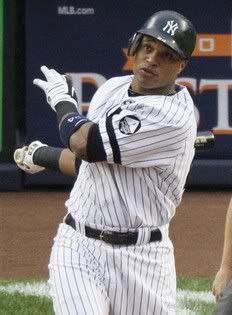 New York Yankees' Robinson Cano watches his solo home run off Texas Rangers starting pitcher C.J. Wilson in the third inning of Game 5 of baseball's American League Championship Series Wednesday, Oct. 20, 2010, in New York.