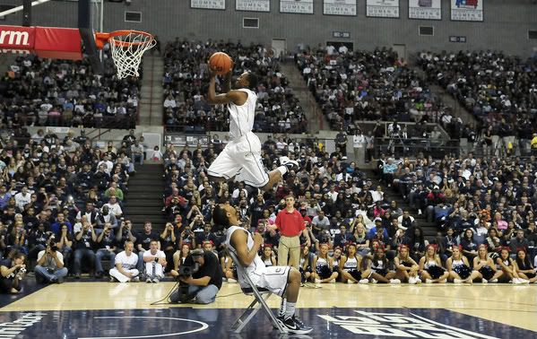 UConn guard Ryan Boatright leaps over guard Shabazz Napier during the dunk contest during the men's and women's basketball teams' First Night celebration Friday night at Gampel Pavilion. Boatright, a freshman, won the contest over freshman Andre Drummond. 