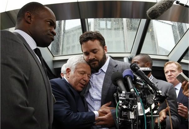 Executive director of the NFL Players Association DeMaurice Smith (L) watches as New England Patriots team owner Robert Kraft (C) gets a hug from Indianapolis Colts center Jeff Saturday (R) outside the NFL Players Association Headquarters in Washington July 25, 2011. The NFL and players have agreed to terms to end their four-month lockout and ensure America's most professional sport will go ahead as planned next season.