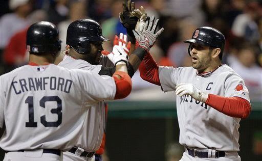 Boston Red Sox's Jason Varitek, right, is greeted by David Ortiz and Carl Crawford (13) after Varitek's two-run home run in the seventh inning of a baseball game against the Cleveland Indians Tuesday, May 24, 2011, in Cleveland.