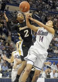 Bria Hartley of UConn gets fouled by Deree Fooks of Towson during the first half Wednesday night at the XL Center in Hartford. Hartley scored 12 points and had 3 assists to help the Huskies lead 52-14 at the half. 