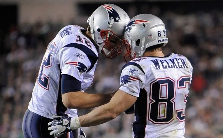 Tom Brady #12 and Wes Welker #83 of the New England Patriots celebrate after Welker caught a 9-yard touchdown reception from Brady in the third quarter against the Philadelphia Eagles at Lincoln Financial Field on November 27, 2011 in Philadelphia, Pennsylvania.