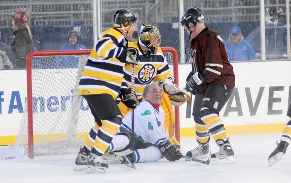 Former Hartford Whaler Andre Lacroix takes a spill trying to score a goal during the Whalers-Bruins alumni-celebrity game at Rentschler Field in East Hartford. At right is celebrity Neal McDonough who appeared in "Minority Report." 