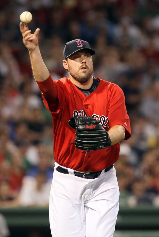 John Lackey(notes) #41 of the Boston Red Sox sends the ball to first for the out against the Seattle Mariners on July 22, 2011 at Fenway Park in Boston, Massachusetts. 