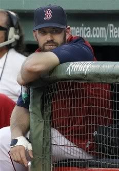 Boston Red Sox's Kevin Youkilis sits in the dugout in the first inning of a baseball game against the Cleveland Indians at Fenway Park in Boston on Tuesday, Aug. 3, 2010.