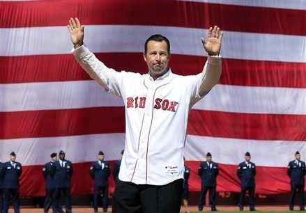 Former Boston Red Sox pitcher Tim Wakefield acknowledges the crowd before throwing a ceremonial first pitch at the home opener of the Boston Red Sox against the Tampa Bay Rays in a baseball game at Fenway Park in Boston, Friday, April 13, 2012