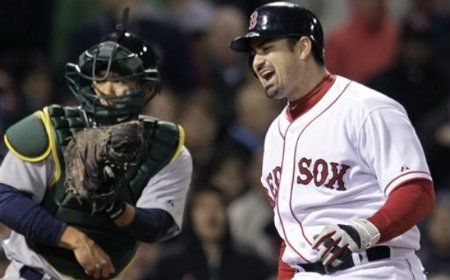 Boston Red Sox's Adrian Gonzalez yells after striking out and leaving the bases loaded in the seventh inning against the Oakland Athletics in a baseball game at Fenway Park in Boston, Wednesday, May 2, 2012. At left is Athletics catcher Kurt Suzuki.