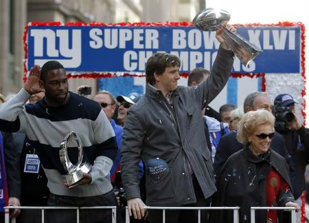 New York Giants' quarterback Eli Manning and defensive end Justin Tuck (L) celebrate during the team's ticker tape victory parade through the Canyon of Heroes along Broadway in honor of their win in the Super Bowl, in New York February 7, 2012.