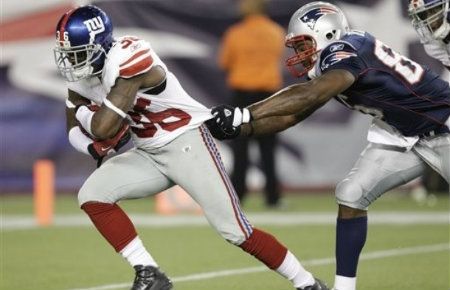 New York Giants defensive back Derrick Martin (36) pulls away from New England Patriots tight end Carson Butler en route to a touchdown after a fumble recovery during the fourth quarter of a preseason NFL football game in Foxborough, Mass. , Thursday, Sept. 1, 2011.