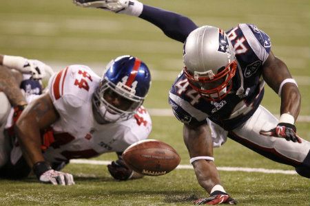 New England Patriots strong safety James Ihedigbo is unable to recover a fourth quarter fumble by New York Giants running back Ahmad Bradshaw (L) at the NFL Super Bowl XLVI football game in Indianapolis, Indiana, February 5, 2012.