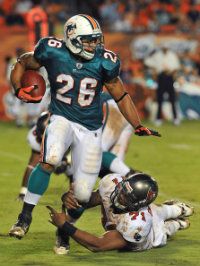 Running back Lex Hilliard #26 of the Miami Dolphins rushes upfield against the Tampa Bay Buccaneers in an opening week, pre-season game August 14, 2010 at Sun Life Stadium in Miami, Florida. 