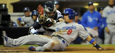Shane Victorino #8 of the Los Angeles Dodgers is tagged out at the plate by Yasmani Grandal #12 of the San Diego Padres as he tries to score during the second inning of a baseball game at Petco Park on September 25, 2012 in San Diego, California.
