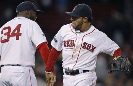 Boston Red Sox shortstop Mike Aviles, right, low-fives teammate David Ortiz after beating the Oakland Athletics, 11-6, in a baseball game at Fenway Park in Boston, Monday, April 30, 2012. Aviles had a three-run homer and Ortiz two solo homers for the Red Sox.