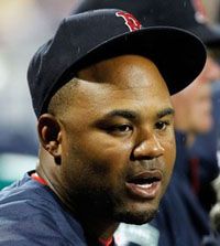 Outfielder Carl Crawford #13 of the Boston Red Sox watches his team from the dugout against the Pittsburgh Pirates during a Grapefruit League Spring Training Game at JetBlue Park on March 9, 2012 in Fort Myers, Florida.